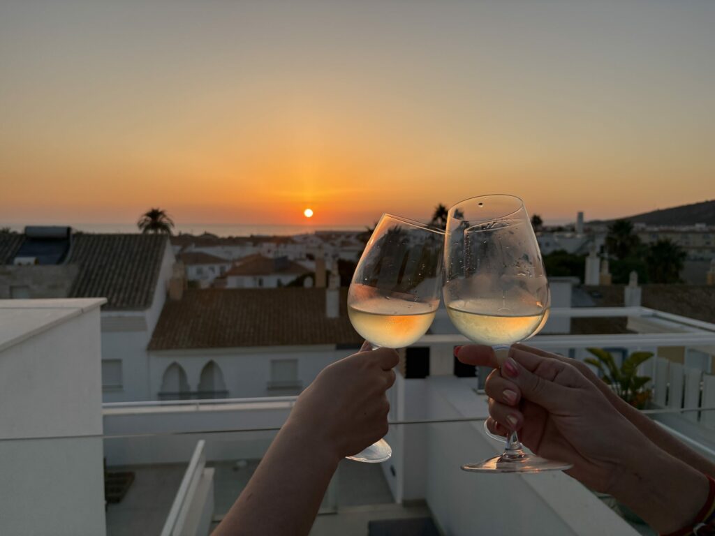 brindis de copas con puesta de sol de fondo