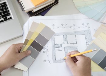 Graphic design and color swatches and pens on a desk. Architectu Graphic design and color swatches and pens on a desk. Architectural drawing with work tools and accessories.
